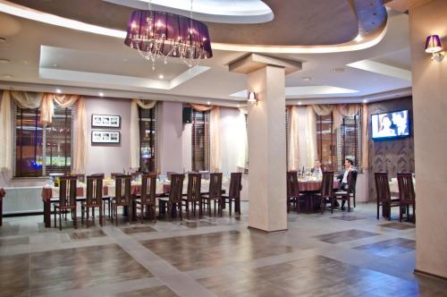 a dining room with a long table and chairs at Luxor Complex in Ivaylovgrad