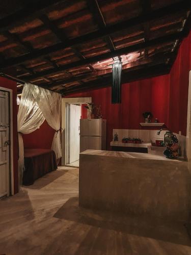 a kitchen with red walls and a refrigerator at Casa Awakening, Beach-front in El Cuyo
