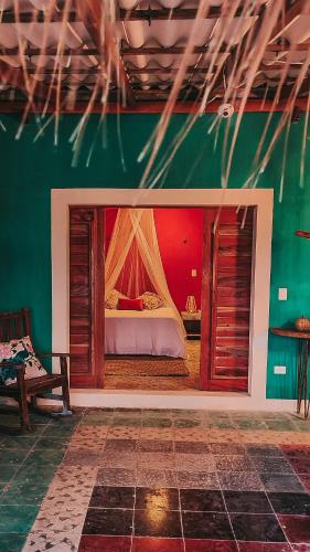 a bedroom with a bed in a green wall at Casa Awakening, Beach-front in El Cuyo