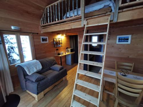 a loft bed in a tiny house at Les cabanes du domaine de l Esperluette in Le Lauzet-Ubaye