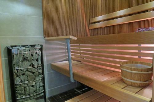a wooden bench in a room with a barrel at Apartments Tahko in Tahkovuori
