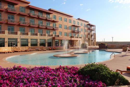 a hotel with a fountain in front of a building at Grand Falls Casino & Golf Resort in Larchwood