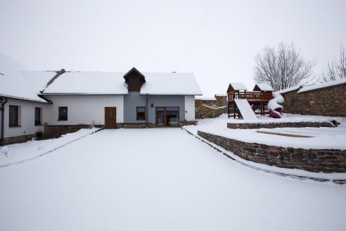 a house covered in snow with a driveway at Hájenka Čenkovice in Čenkovice
