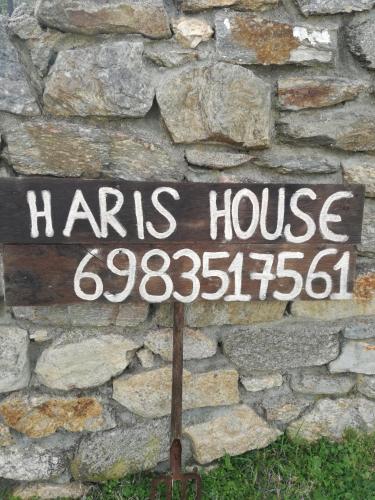 a sign that says harris house on a stone wall at Villa Haris in Sarti