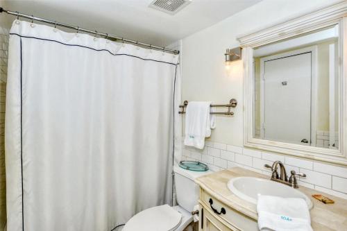 a bathroom with a toilet and a sink at LaPlaya 104E Perfectly located near the path to the beach just steps from the pool in Longboat Key