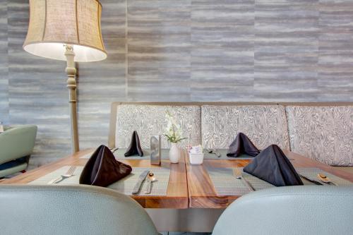 a dining room table with a lamp and chairs at Crowne Plaza Charleston by IHG in Charleston