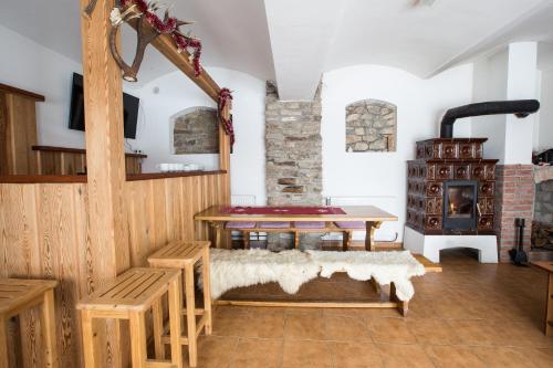 a living room with a table and a fireplace at Hájenka Čenkovice in Čenkovice