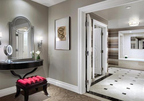 a bathroom with a mirror, a sink and a bathtub at The Palazzo at The Venetian® in Las Vegas