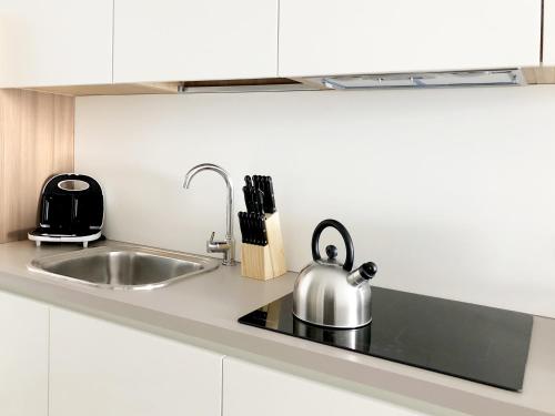 a kitchen with a sink and a tea kettle at Residence Aurora in Lavarone
