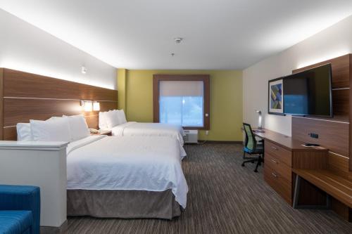 a hotel room with two beds and a flat screen tv at Holiday Inn Express Arlington Interstate 20 Parks Mall by IHG in Arlington