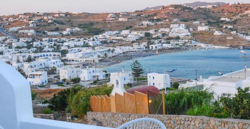 a view of a town with white buildings and the ocean at Modern Cycladic Sea View House in Ornos