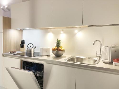 a kitchen with a sink and a bowl of fruit at Residence Aurora in Lavarone