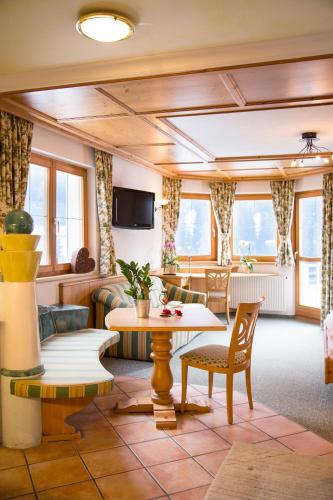 a living room with a table and chairs at Fliana Arlberg Studios - Apartments in Sankt Anton am Arlberg