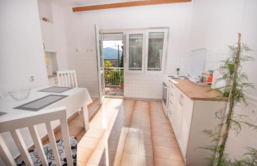 a kitchen with a table and a counter top at Ranko Apartments in Risan