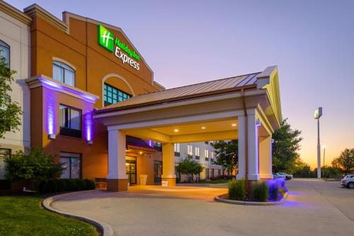 a hospital building with a lit up sign on it at Holiday Inn Express Bloomington West by IHG in Bloomington