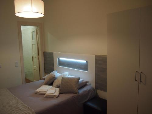 a bedroom with a bed with two pillows on it at Green View Home in Lisbon