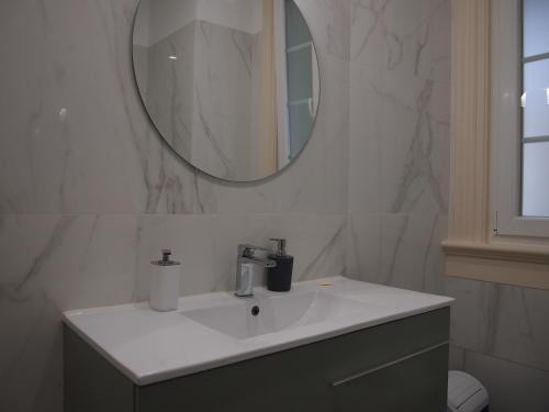 a bathroom with a sink and a mirror on the wall at Green View Home in Lisbon