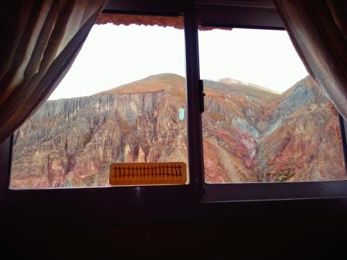 a view of a canyon from a window at Hospedaje Ale in Iruya