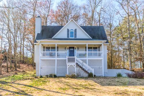 a white house with a gambrel roof at Explore Historic DT In This Cozy Open Air 5BR Stay in Cartersville