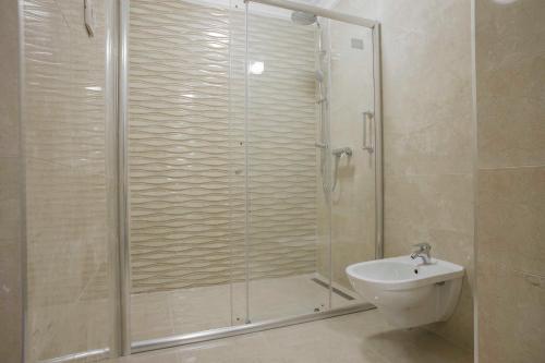 a bathroom with a shower with a toilet and a sink at Hotel Adrović in Sveti Stefan