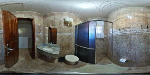 a bathroom with a toilet and a sink and a shower at RECANTO CANTAGALO Hotel in Cantagalo