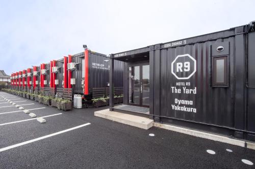 a row of train cars parked in a parking lot at HOTEL R9 The Yard Oyamayokokura in Oyama