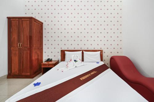 a bedroom with a bed with shoes on it at Paradise Hotel in Củ Chi