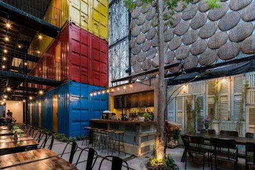 a restaurant with colorful walls and tables and chairs at Ccasa Hostel in Nha Trang