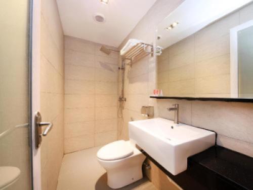 a bathroom with a white toilet and a sink at De Cyber Boutique Hotel in Cyberjaya