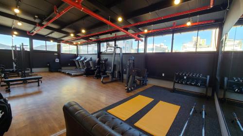 a gym with rows of treadmills and equipment in a building at Benikea Hotel Yangsan in Yangsan