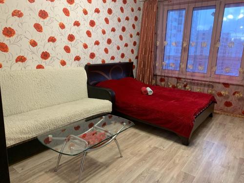 En eller flere senge i et værelse på Уютная квартира на Захарова