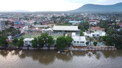 a city next to a body of water with buildings at The B Resort in Kampot