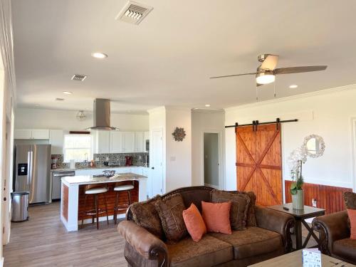 a living room with a couch and a kitchen at Bungalow Beach house 100 yards from the beach in Bay Saint Louis