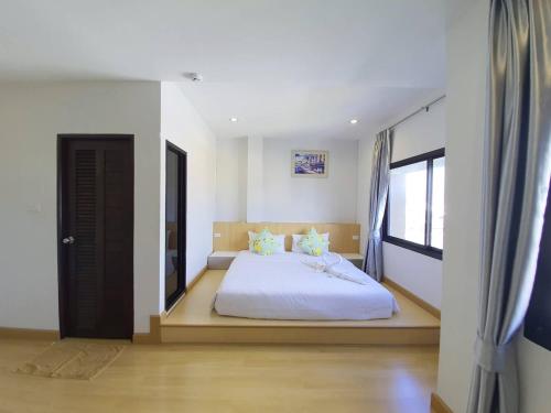 a bedroom with a bed and a large window at Klongrien Boutique Hotel in Hat Yai