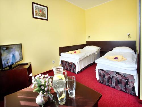Postel nebo postele na pokoji v ubytování Hotel Milan Vopicka