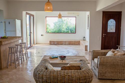 a living room with two couches and a table at Rhodes Retreat in Kalithies