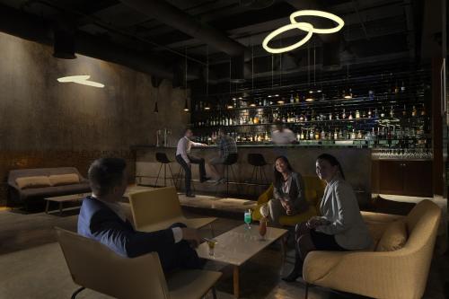 a group of people sitting around a bar at InterContinental Bahrain by IHG in Manama
