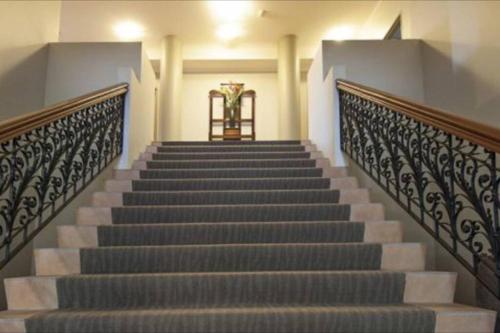 a staircase in a building with a vase of flowers at Tropical One Bedroom Apartment at The Mediterranean in Port Douglas
