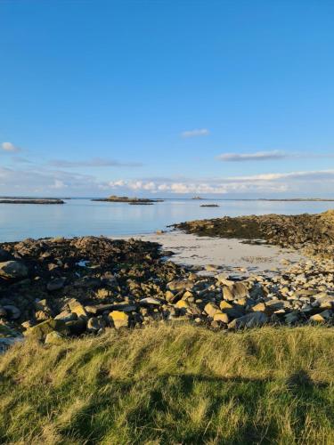 a rocky beach with the ocean in the background at Dépendance Spacieuse & Cosy Entre et Mer avec Spa in Landéda