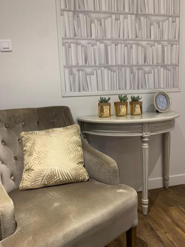 a living room with a couch and a table at Hotel Les Embruns in Le Touquet-Paris-Plage