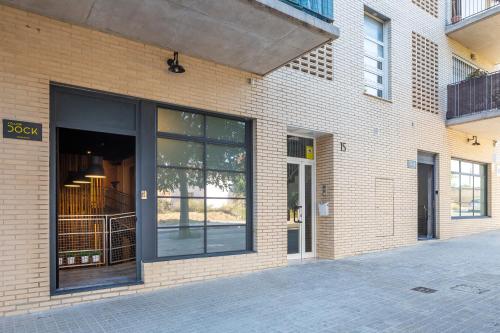 a brick building with a large window on it at ART LOFTS Valencia by Benisur in Valencia