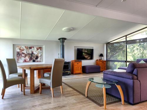 una sala de estar con un sofá y una mesa en Cabins @ The View, en Ocean View