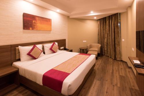 a bedroom with a bed in a hotel room at Le Roi Digha in Digha