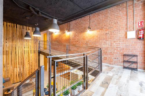 a room with a brick wall and some lights at ART LOFTS Valencia by Benisur in Valencia