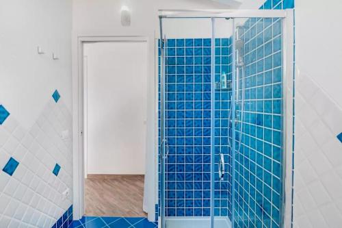 a bathroom with a shower with blue tile at Casa Vacanze Porto Istana in Murta Maria