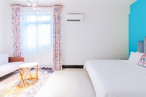 a bedroom with a bed and a chair and a window at 林居民宿 in Jinhu