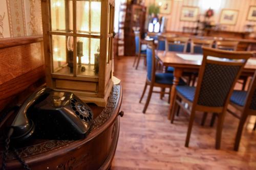 a telephone in a room with a table and chairs at Dwór Ostoia in Rymanów
