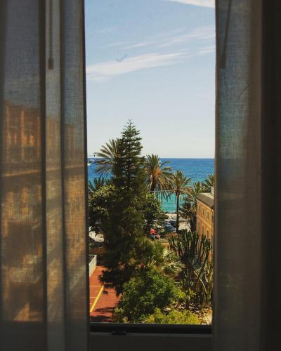 a view of the ocean from a window at Hotel Villa Sophia in Sanremo