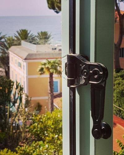 a door latch on a door with a view of the ocean at Hotel Villa Sophia in Sanremo