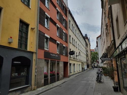an empty street in a city with buildings at Hotel Falkenturm in Munich